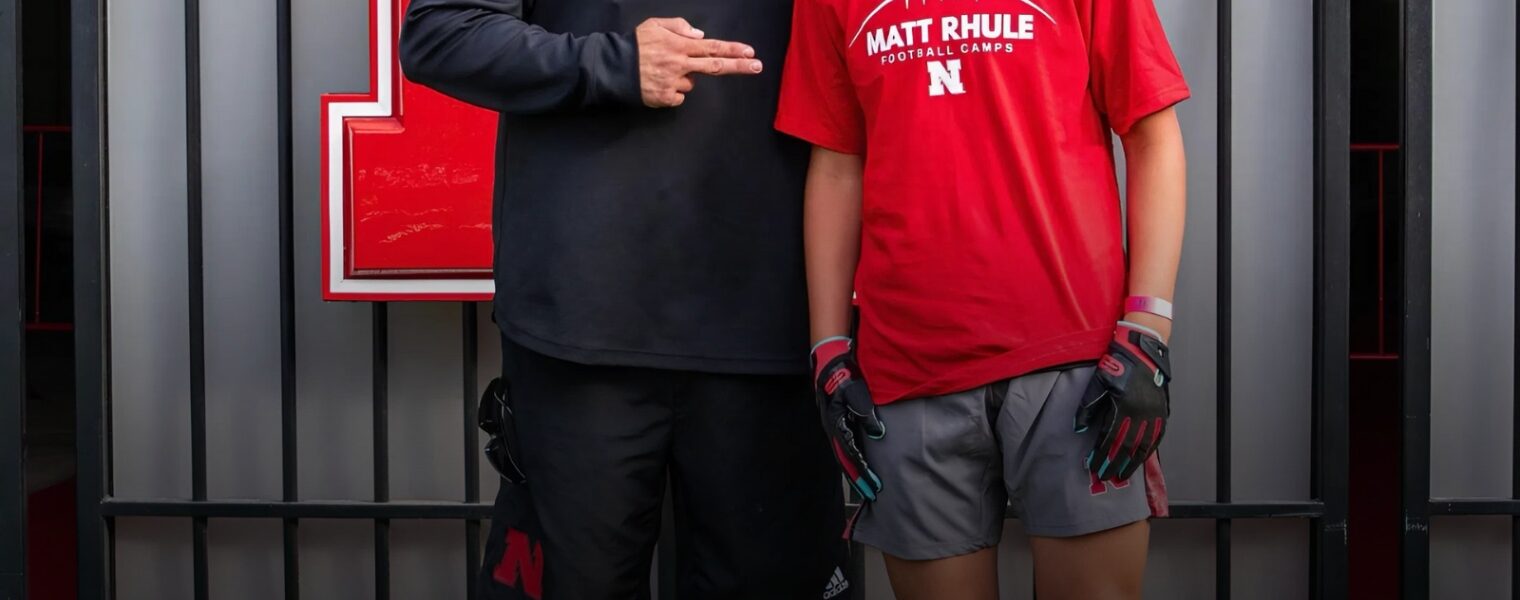 Nebraska head coach Matt Rhule met a young fan who dreamed of Huskers football but whose family was struggling. After taking a photo together, Rhule quietly stepped in — covering the boy’s camp fees and sending him home with brand-new Huskers gear, a moment that turned quiet hardship into unforgettable joy.
