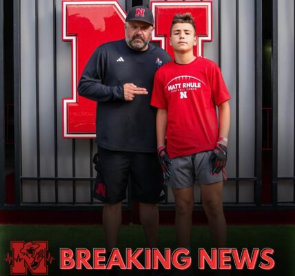 Nebraska head coach Matt Rhule met a young fan who dreamed of Huskers football but whose family was struggling. After taking a photo together, Rhule quietly stepped in — covering the boy’s camp fees and sending him home with brand-new Huskers gear, a moment that turned quiet hardship into unforgettable joy.